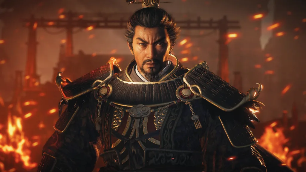 Close-up of a bearded warlord in ornate dark armour against a burning, smoky background.