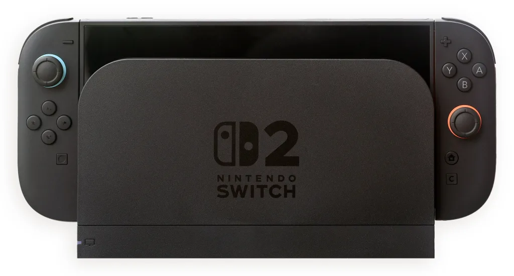 A black Nintendo Switch 2 console standing in its dock, with Joy-Con 2 controllers attached.